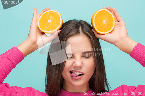 Image of Beautiful woman\'s face with juicy orange