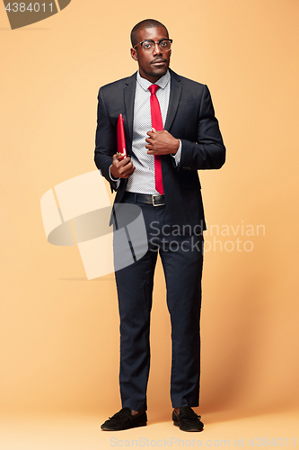 Image of Handsome Afro American man standing with a laptop