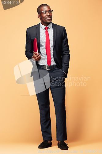 Image of Handsome Afro American man standing with a laptop