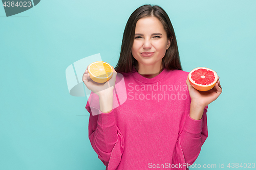 Image of Beautiful woman\'s face with juicy orange