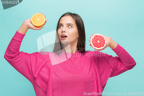 Image of Beautiful woman\'s face with juicy orange