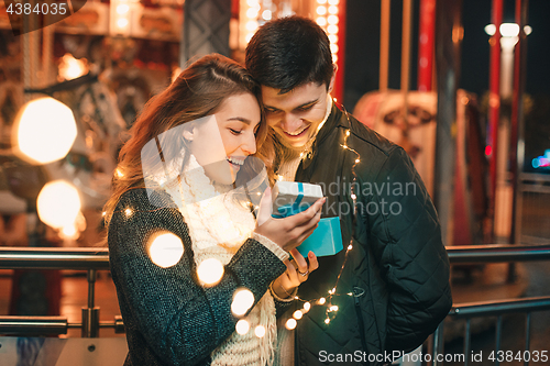 Image of romantic surprise for Christmas, woman receives a gift from her boyfriend