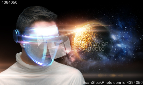 Image of man in 3d glasses over planet and space