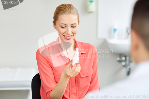 Image of woman with nasal spray and doctor at hospital