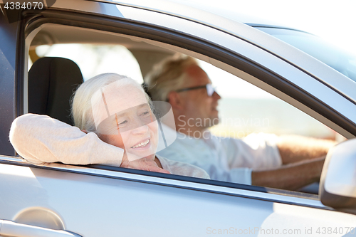 Image of happy senior couple driving in car