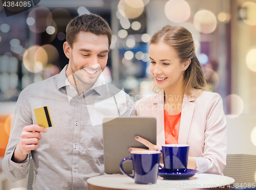 Image of couple with tablet pc and credit card in mall