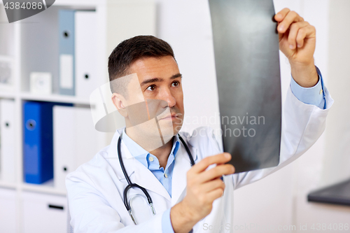 Image of male doctor or surgeon with x-ray at hospital