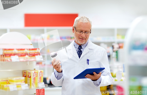 Image of senior with tablet pc at pharmacy