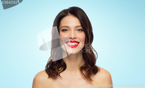 Image of beautiful smiling young woman with red lipstick