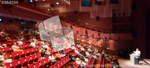 Image of Business speaker giving a talk in conference hall.