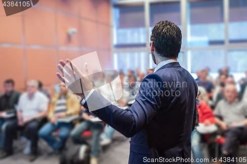 Image of Speaker Giving a Talk at Business Meeting.