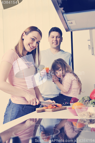 Image of happy young family in kitchen