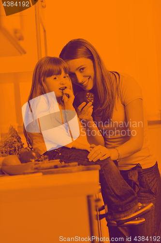 Image of happy daughter and mom in kitchen