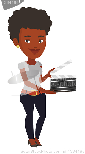 Image of Smiling woman holding an open clapperboard.