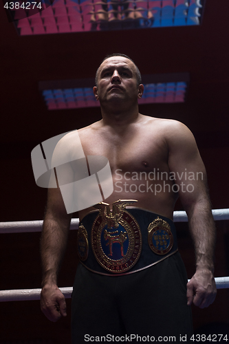 Image of kick boxer with his championship belt