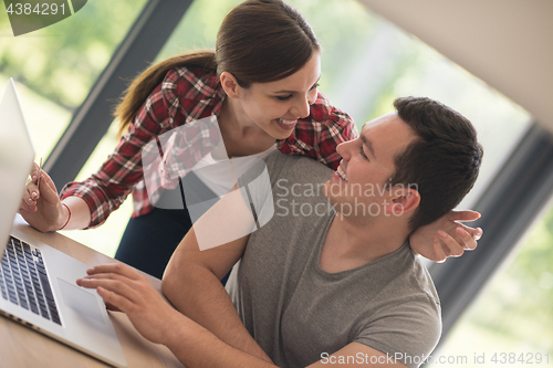 Image of happy young couple buying online