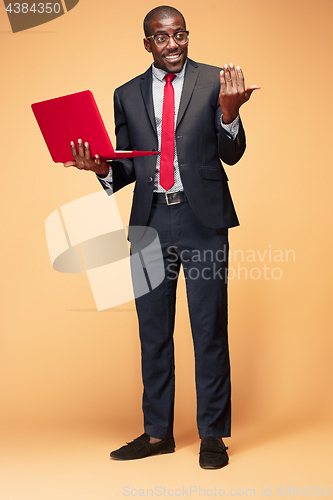 Image of Handsome Afro American man sitting and using a laptop