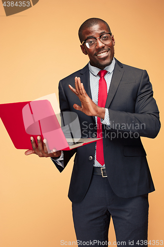 Image of Handsome Afro American man sitting and using a laptop