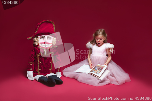 Image of The beauty ballerina sitting with nutcracker