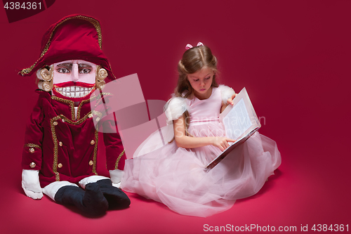 Image of The beauty ballerina sitting with nutcracker