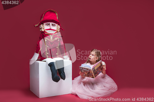 Image of The beauty ballerina sitting with nutcracker