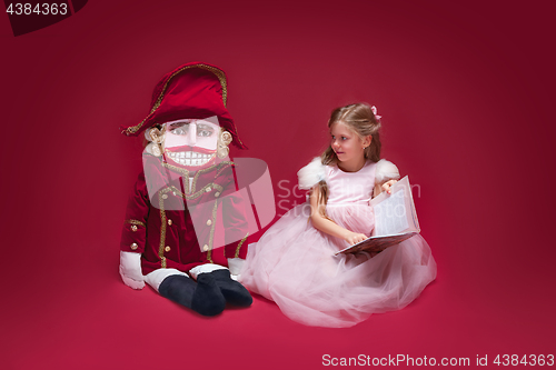 Image of The beauty ballerina sitting with nutcracker