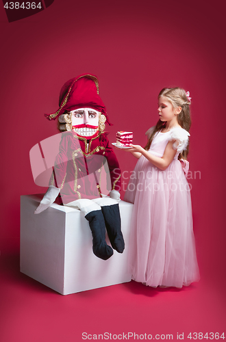 Image of The beauty ballerina standing with nutcracker