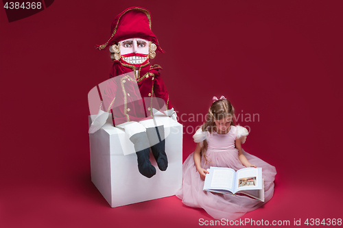 Image of The beauty ballerina sitting with nutcracker