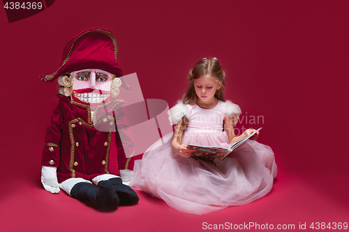 Image of The beauty ballerina sitting with nutcracker