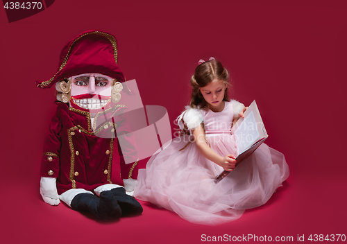 Image of The beauty ballerina sitting with nutcracker