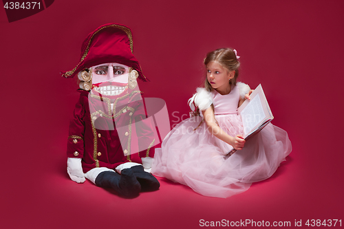 Image of The beauty ballerina sitting with nutcracker