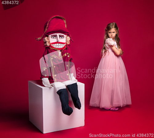 Image of The beauty ballerina standing with nutcracker