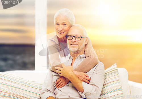 Image of happy senior couple over sunset background