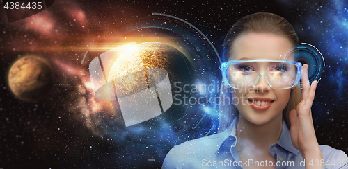 Image of woman in virtual reality glasses over space