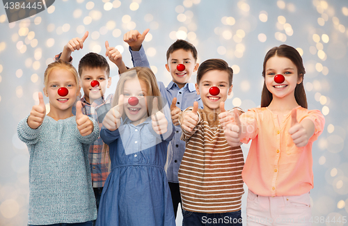 Image of happy children showing thumbs up at red nose day