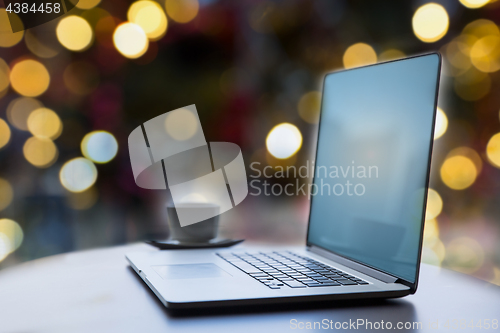 Image of laptop and coffee cup on table at christmas