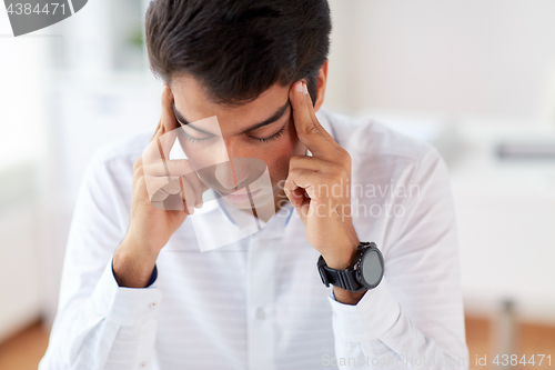 Image of close up of stressed businessman at office