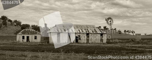 Image of Rural farmlands windmill and outbuildings