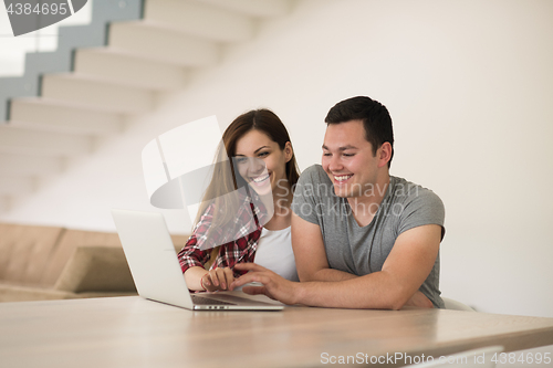 Image of happy young couple buying online