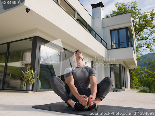 Image of man doing morning yoga exercises