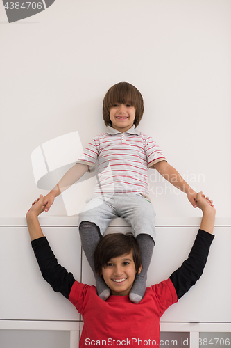 Image of young boys posing line up piggyback