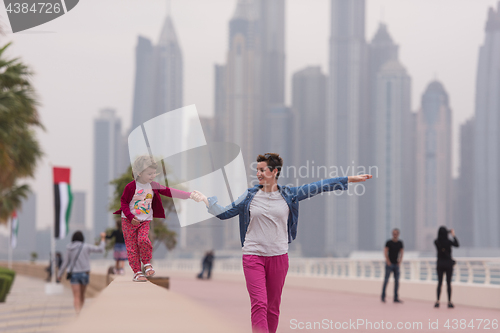 Image of mother and cute little girl on the promenade