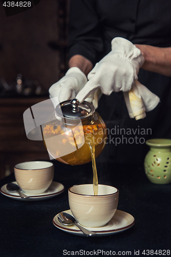 Image of Pouring tea with sea buckthorn