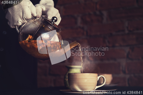 Image of Pouring tea with sea buckthorn