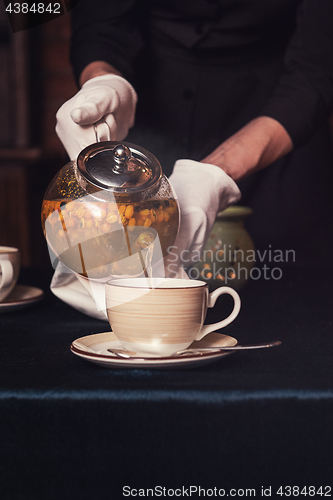 Image of Pouring tea with sea buckthorn