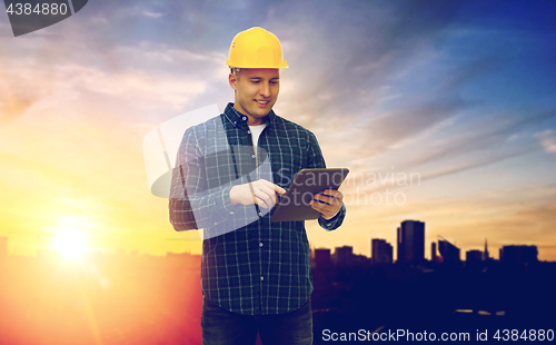 Image of male builder in yellow hard hat with tablet pc