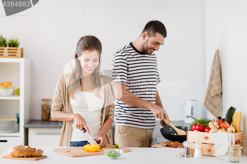 Image of couple cooking food at home kitchen