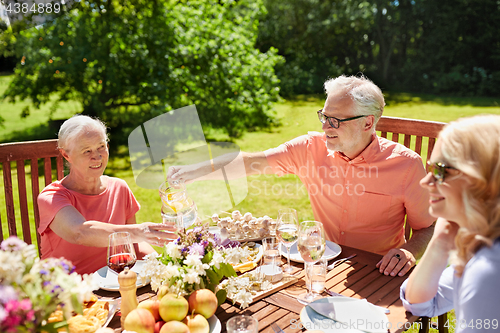 Image of happy family having dinner or summer garden party