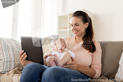 Image of happy mother and baby boy with tablet pc at home