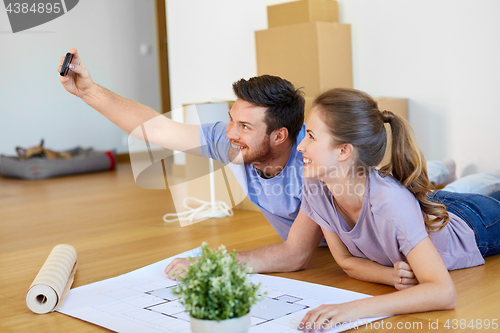 Image of couple taking selfie and moving to new home